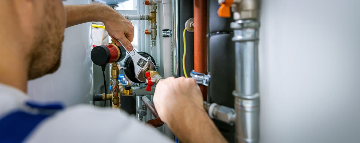 Plumber repairing heating system or boiler installation